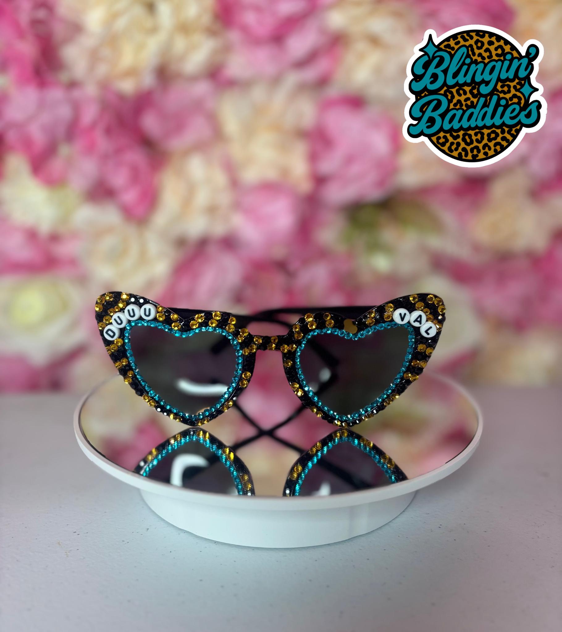 DUUUVAL rhinestone heart sunglasses with teal and gold crystals displayed on white dish, Jaguars gameday accessory