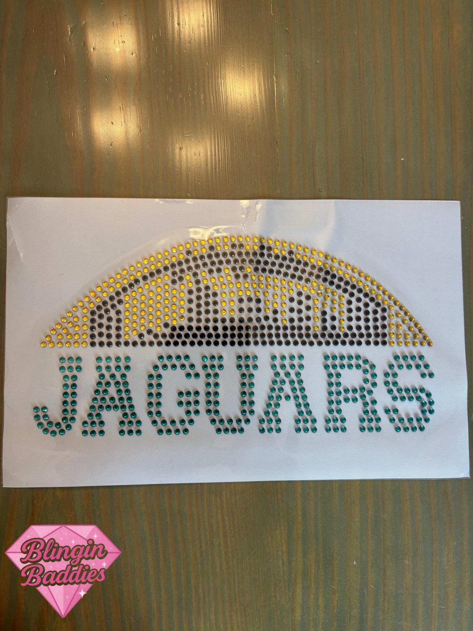 JAGUARS rhinestone heat transfer with teal letters and gold football skyline, Jacksonville gameday bling