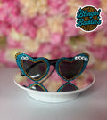 GO JAGS rhinestone heart sunglasses with teal crystals and gold accents on white dish, Jaguars game day bling